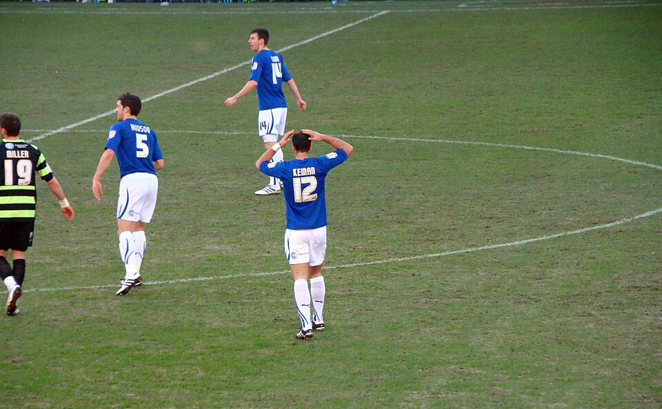 Vista aérea de un partido intenso con equipos presionando en bloque